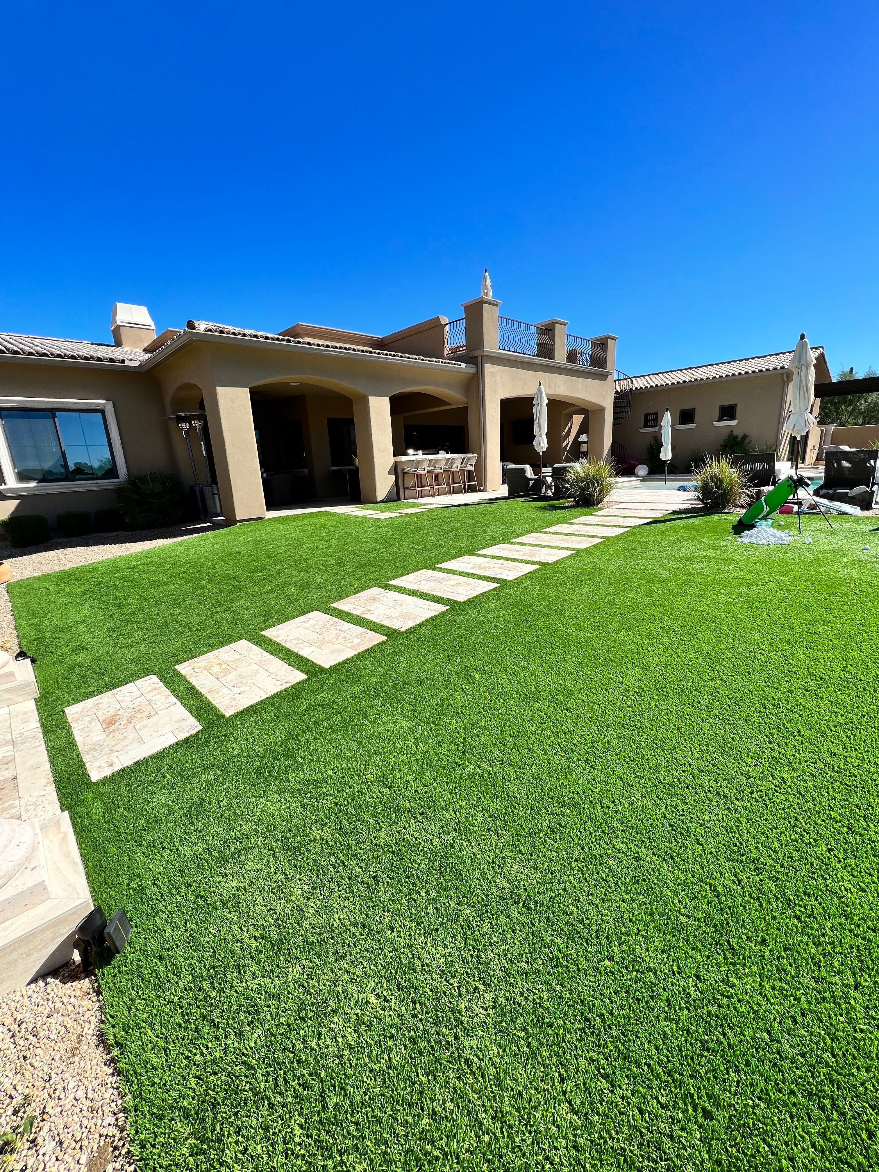 Well-maintained artificial turf backyard cared for by Zeo Turf Cleaning